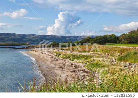 Wild coastal beach with hills and clouds on Scottish west coast Wild coastal beach with hills and clouds on Scottish west coast 132821590
