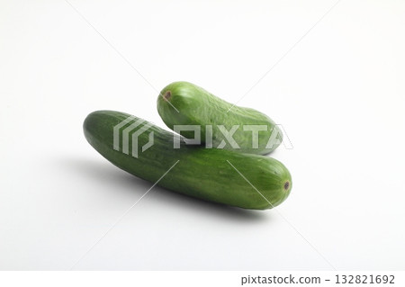 whole peeled and unpeeled fresh cucumber on white background 132821692