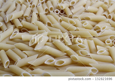Delicious pasta, penne noodles background. Top view scene, healthy eating or healthy lifestyle. Penne 132821696