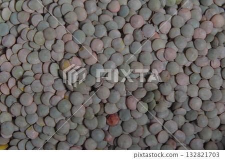 Close up of dried green lentils. Green lentils pattern as background. Close up of dried green lentils. Green lentils pattern as background. 132821703