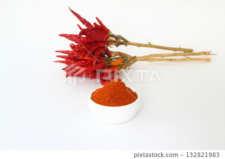 red dried crushed hot chili peppers and chili flakes or powder isolated on white background red dried crushed hot chili peppers and chili flakes or powder isolated on white background 132821983