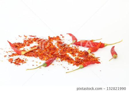 red dried crushed hot chili peppers and chili flakes or powder isolated on white background red dried crushed hot chili peppers and chili flakes or powder isolated on white background 132821990