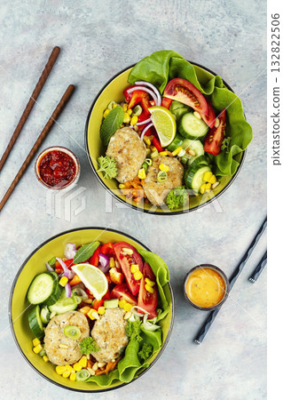 Fried cutlets in buddha bowl, fish patties. 132822506