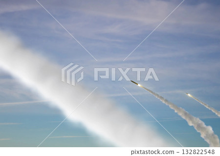 Military rockets are flying against the sky, smoke and fire from the rocket. Concept: missile attack, air alert, war between Russia and Ukraine, missile strike, shelling. Military rockets are flying against the sky, smoke and fire from the rocket. Concept: missile attack, air alert, war between Russia and Ukraine, missile strike, shelling. 132822548
