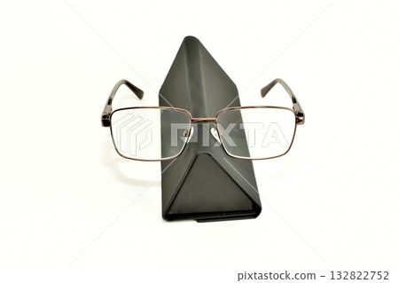 Glasses in a triangle-shaped case made of dark material Glasses in a triangle-shaped case made of dark material 132822752