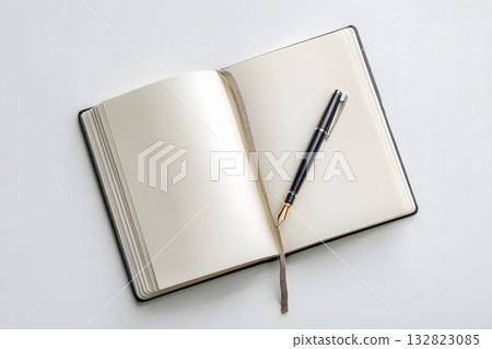 Minimalist Writing Setup Featuring Open Journal and Pen on Clean Surface 132823085