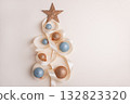 Minimalist Christmas Tree Made of Ribbon and Ornaments on Light Background 132823320