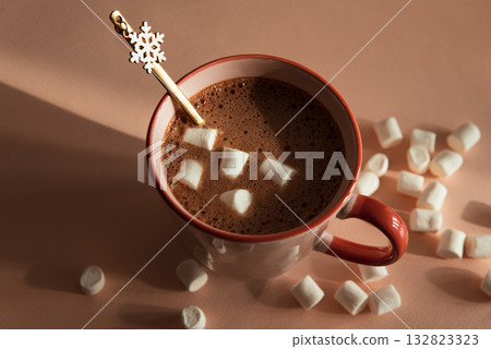 Hot Chocolate with Marshmallows and Snowflake Spoon in Pink Mug Hot Chocolate with Marshmallows and Snowflake Spoon in Pink Mug 132823323