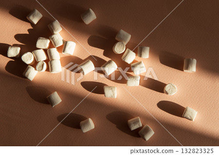 Mini Marshmallows with Shadows on Brown background 132823325