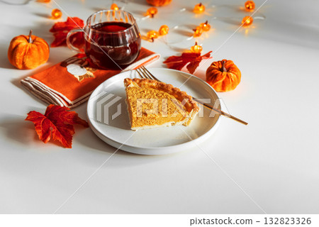 Pumpkin Pie Slice with Autumn Drink and Festive Table Decor Pumpkin Pie Slice with Autumn Drink and Festive Table Decor 132823326