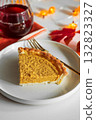 Pumpkin Pie Slice with Autumn Drink and Festive Table Decor 132823327