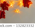 Autumn Leaves and Warm Pumpkin Lights on White Background 132823332