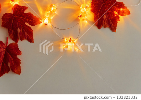 Autumn Leaves and Warm Pumpkin Lights on White Background 132823332