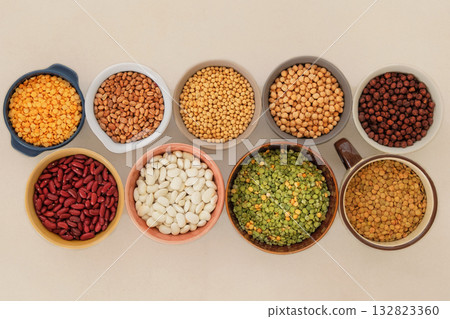 Top view.  Protein products for vegetarians. Soy, lentils, peas, chickpeas and various types of beans in bowls. Variety of nutrients. 132823360