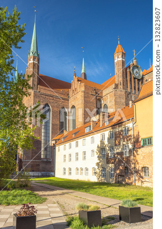 St. Mary's Church in Gdansk, a city on the Baltic coast of northern Poland, Europe. Historic cathedral with soaring spires, set against a clear blue sky, showcasing architectural grandeur. St. Mary's Church in Gdansk, a city on the Baltic coast of northern Poland, Europe. Historic cathedral with soaring spires, set against a clear blue sky, showcasing architectural grandeur. 132823607