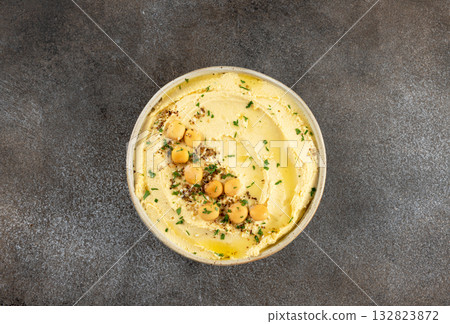 Lupini bean hummus with olive oil and herbs on gray background. Vegetarian food. Top view. 132823872