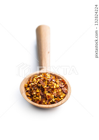 Red chili peppers flakes. Milled spicy peppers and isolated on white background. 132824224