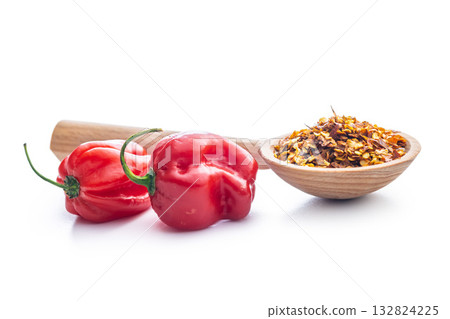 Red chili peppers flakes. Milled spicy peppers and habanero isolated on white background. 132824225