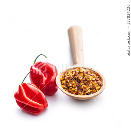 Red chili peppers flakes. Milled spicy peppers and habanero isolated on white background. 132824226
