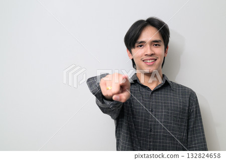 Portrait of handsome Young Asian Thai man pointing finger against white background 132824658