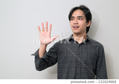 Portrait of handsome Young Asian Thai man against white background 132824668