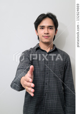 Portrait of handsome Young Asian Thai man offering handshake against white background 132824669