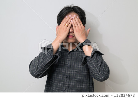 Portrait of handsome Young Asian Thai man see no evil gesture against white background 132824678
