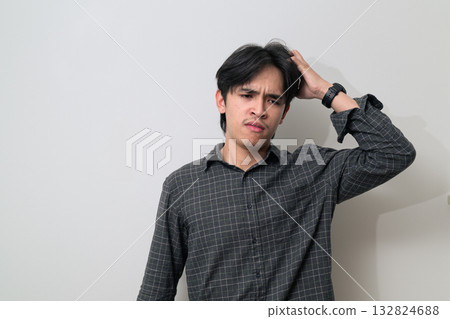 Portrait of handsome Young Asian Thai man looking stressed and worried against white background 132824688