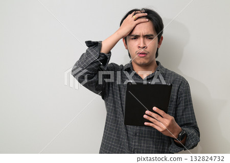 Portrait of handsome Young Asian Thai man using digital tablet computer against white background 132824732