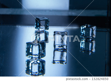6.Five Ice Cubes on Blue Reflective Surface in Studio 6.Five Ice Cubes on Blue Reflective Surface in Studio 132824850