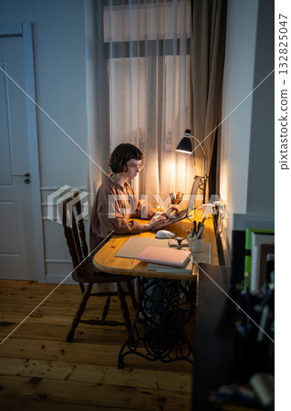 Overwhelmed exhausted young woman battles deadlines on laptop in chaotic night shift at home Overwhelmed exhausted young woman battles deadlines on laptop in chaotic night shift at home 132825047