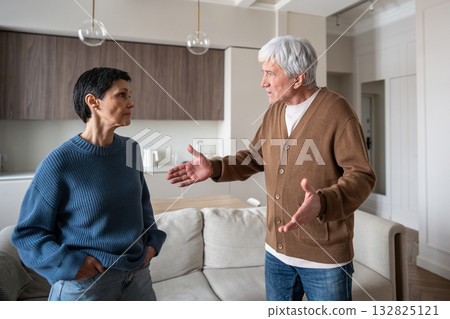 Upset mature couple fighting, man gesturing on disagreement. Marital strife, relationship struggle Upset mature couple fighting, man gesturing on disagreement. Marital strife, relationship struggle 132825121