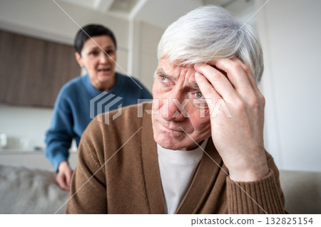 Exhausted senior husband silently bear relentless verbal assault from shouting wife, mental burden 132825154
