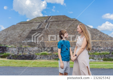 Mother and her son as tourists in front of Teotihuacan pyramids, Mexico, enjoying sightseeing, family travel, and cultural exploration together Mother and her son as tourists in front of Teotihuacan pyramids, Mexico, enjoying sightseeing, family travel, and cultural exploration together 132825342