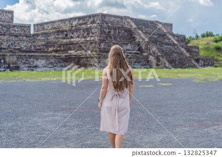 Female tourist standing in front of Teotihuacan pyramids in Mexico, enjoying sightseeing, adventure, and cultural heritage. Travel, tourism, and exploration concept 132825347