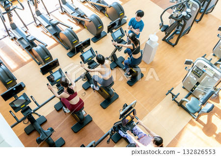 Aerial view of men and women exercising at a fitness gym 132826553