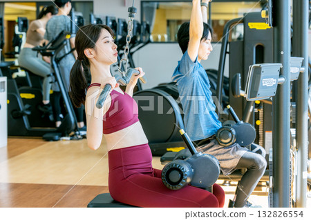 Young woman exercising at the fitness gym Young woman exercising at the fitness gym 132826554