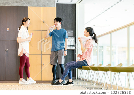 Men and women chatting in the gym locker room Men and women chatting in the gym locker room 132826558