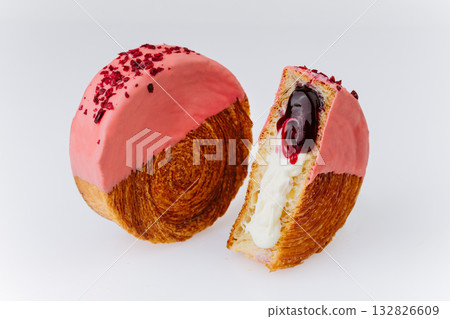 Pink glazed croissant roll with cream and cherry filling isolated on white background 132826609