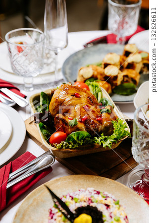 Roasted chicken with pomegranate and vegetables served on festive holiday table 132826611