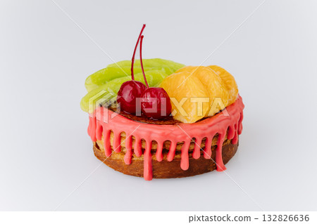 Colorful fruit pastry with red glaze, kiwi, tangerine, and cherries on white background 132826636