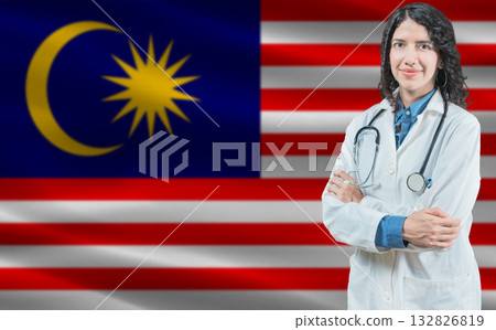 Malaysian medicine and healthcare concept. Close up of doctor against Malaysia flag background 132826819