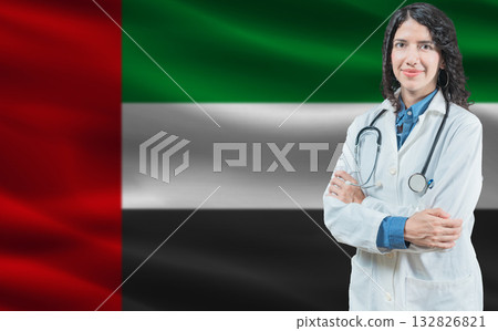 Emirati medicine and healthcare concept. Close up of doctor against United Arab Emirates flag background 132826821