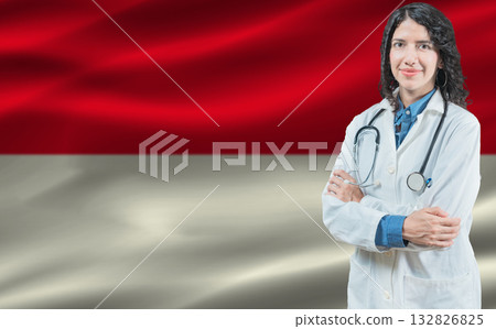 Indonesian medicine and healthcare concept. Doctor close up against Indonesia flag background Indonesian medicine and healthcare concept. Doctor close up against Indonesia flag background 132826825