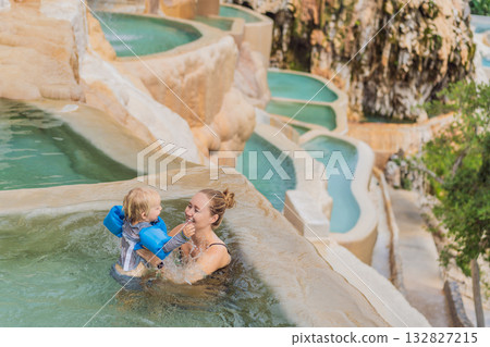 Mother and her toddler bathing in the hot springs of Grutas Tolantongo, Mexico, enjoying family bonding, wellness, and outdoor adventure concept 132827215