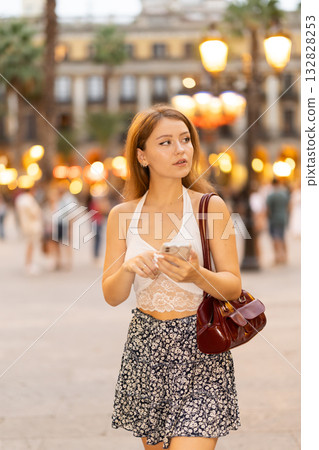 Young woman walking in Royal Square (Placa Real) in Barcelona 132828253