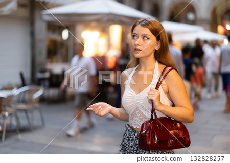 Young woman walking in Royal Square (Placa Real) in Barcelona Young woman walking in Royal Square (Placa Real) in Barcelona 132828257