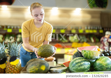 Woman choosing melon at the market Woman choosing melon at the market 132828285