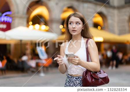 Woman walking around Barcelona, she has visited Placa real and plans to spend the evening in bars and restaurants with friends Woman walking around Barcelona, she has visited Placa real and plans to spend the evening in bars and restaurants with friends 132828334