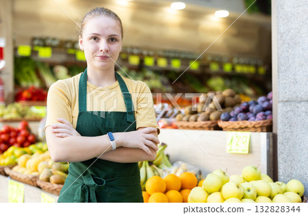 Young woman seller in vegetable shop Young woman seller in vegetable shop 132828344